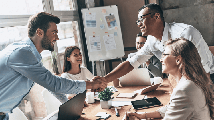 Employees as a company welcoming a new person with a handshake