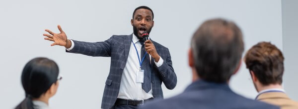 man with microphone hosting a live quiz